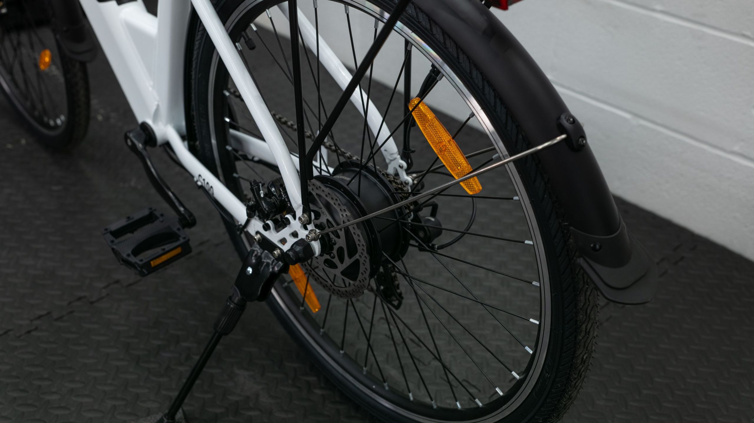 a rear wheel hub motor on a white ebike