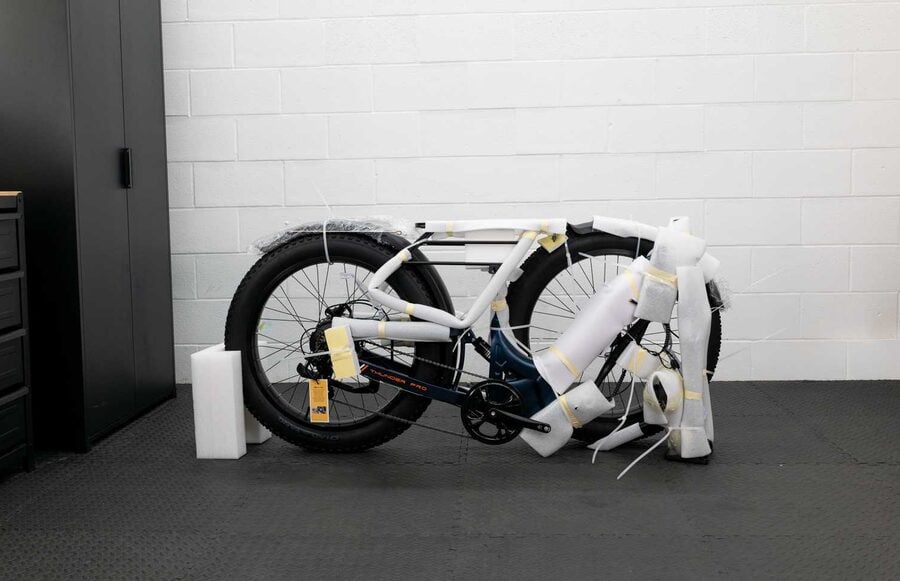 A test e-bike still boxed and wrapped in the BikeRide studio