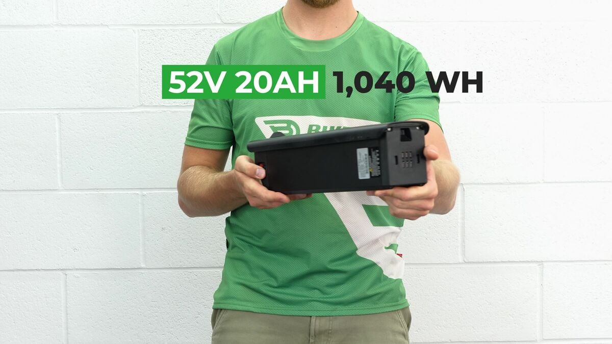 A tester holding a removable battery pack with its capacity labeled